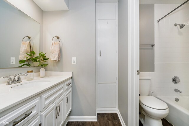 3852 Knollton Rd Unit 3852, Indianapolis, IN 46228 - full bath with wood finished floors, toilet, vanity, shower / washtub combination, and baseboards