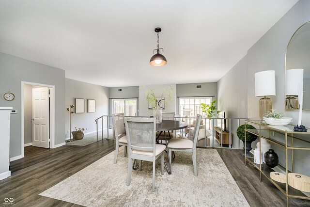 3852 Knollton Rd Unit 3852, Indianapolis, IN 46228 - dining area featuring wood finished floors, baseboards, and arched walkways