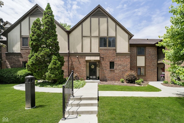 3852 Knollton Rd Unit 3852, Indianapolis, IN 46228 - tudor-style house featuring brick siding, a front lawn, and stucco siding