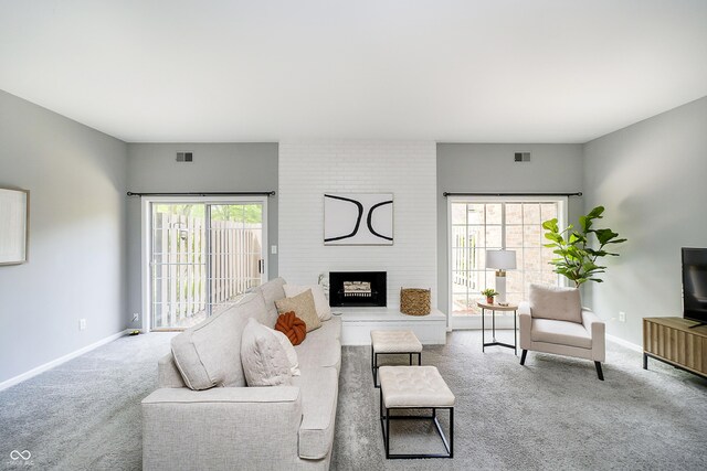 3852 Knollton Rd Unit 3852, Indianapolis, IN 46228 - living room featuring carpet, baseboards, and a fireplace
