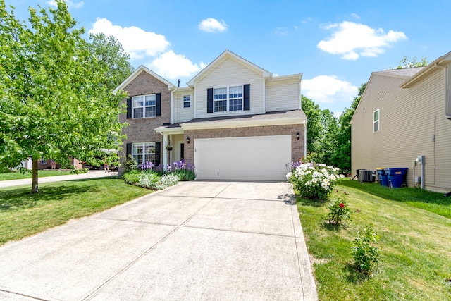 5145 Greenside Dr, Indianapolis, IN 46235 - traditional-style house with an attached garage, driveway, a front yard, central AC, and brick siding