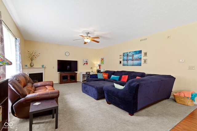 5145 Greenside Dr, Indianapolis, IN 46235 - living room featuring a ceiling fan, a fireplace, and wood finished floors