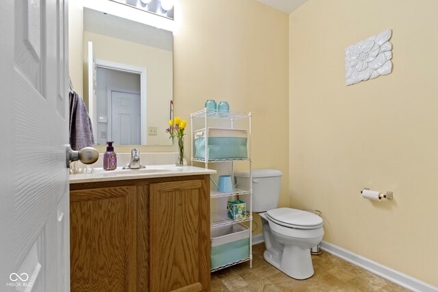 5145 Greenside Dr, Indianapolis, IN 46235 - half bathroom featuring toilet, vanity, and baseboards