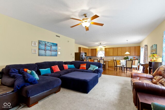 5145 Greenside Dr, Indianapolis, IN 46235 - living room featuring healthy amount of natural light, a ceiling fan, and light carpet