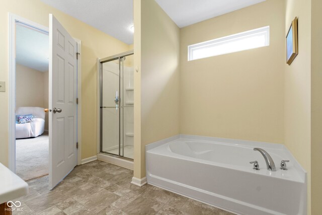 5145 Greenside Dr, Indianapolis, IN 46235 - full bathroom featuring a stall shower, a bath, and baseboards