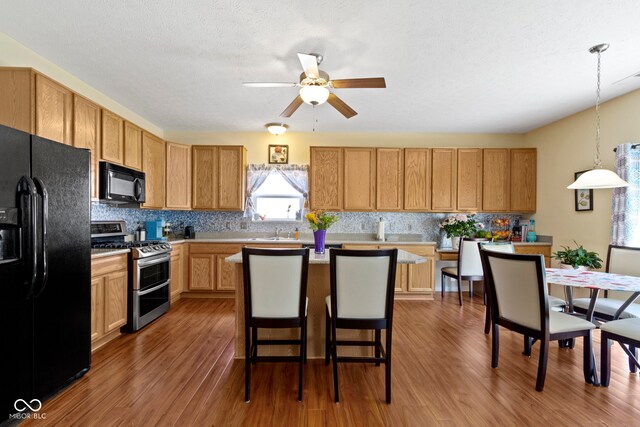 5145 Greenside Dr, Indianapolis, IN 46235 - kitchen with black appliances, backsplash, a sink, and wood finished floors