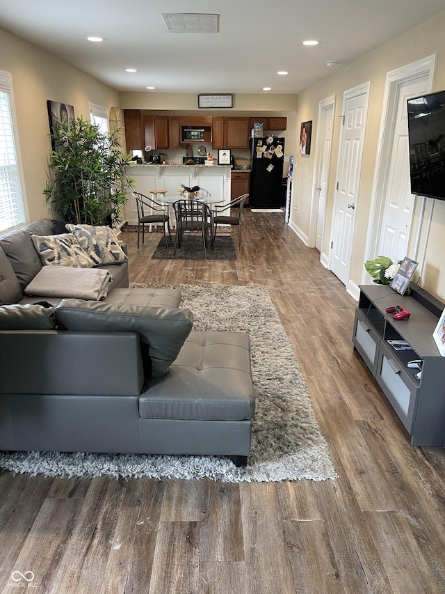 1931 E 68th St, Indianapolis, IN 46220 - living area with dark wood finished floors, recessed lighting, and baseboards