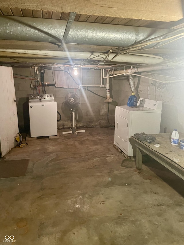 unfinished below grade area featuring separate washer and dryer