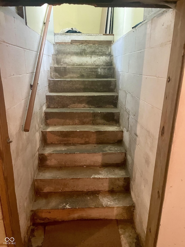 stairs with concrete block wall