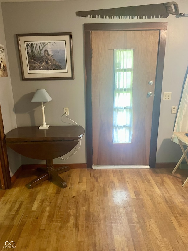 foyer entrance featuring wood finished floors and baseboards