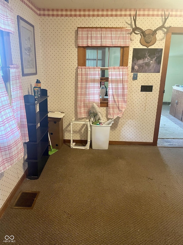 dining space with carpet flooring and wallpapered walls