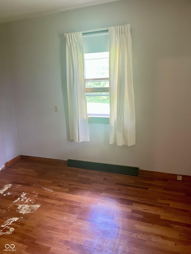 spare room featuring wood finished floors