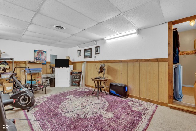 1104 Briarwood Dr, Brownsburg, IN 46112 - workout area featuring a paneled ceiling, carpet floors, wainscoting, wood walls, and washer / clothes dryer
