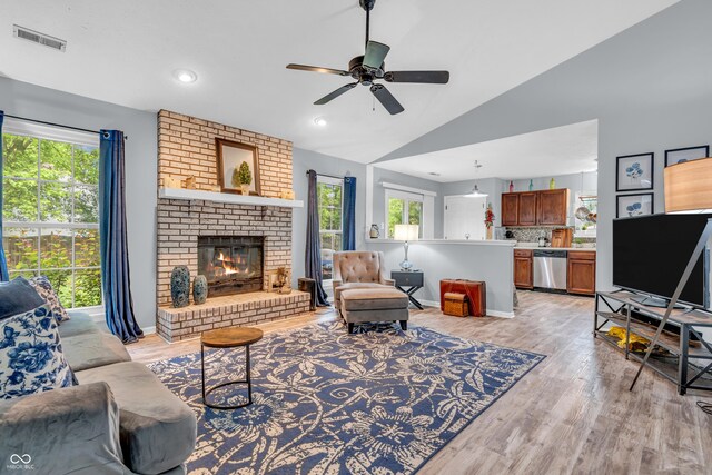 1104 Briarwood Dr, Brownsburg, IN 46112 - living room with healthy amount of natural light, ceiling fan, lofted ceiling, light wood-type flooring, and a fireplace