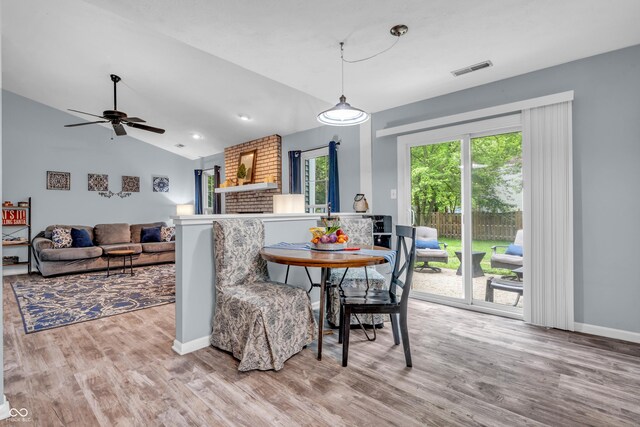 1104 Briarwood Dr, Brownsburg, IN 46112 - dining space featuring wood finished floors, vaulted ceiling, a ceiling fan, and baseboards