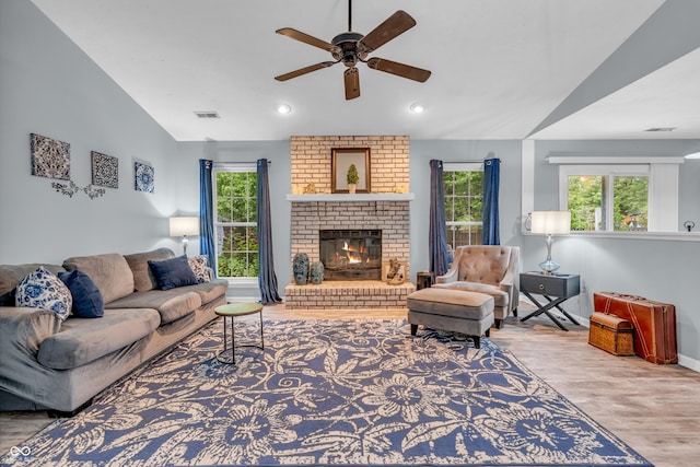 1104 Briarwood Dr, Brownsburg, IN 46112 - living room featuring a ceiling fan, lofted ceiling, plenty of natural light, wood finished floors, and a brick fireplace