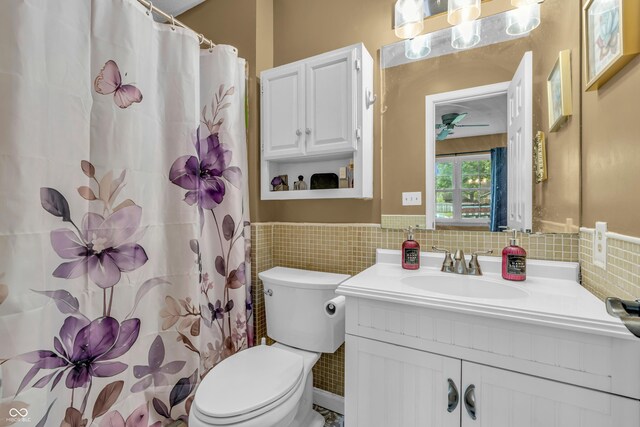 1104 Briarwood Dr, Brownsburg, IN 46112 - full bath with tile walls, vanity, toilet, wainscoting, and ceiling fan