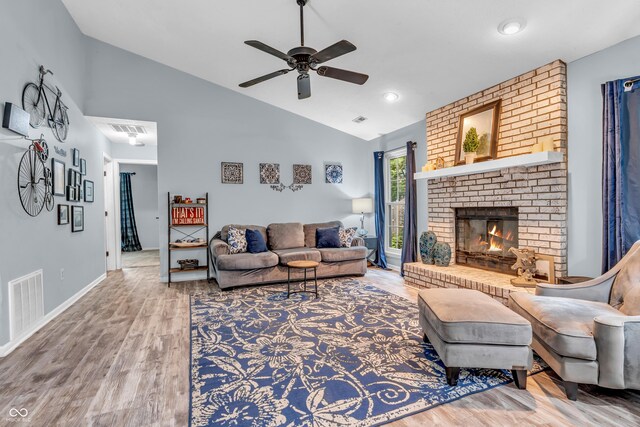 1104 Briarwood Dr, Brownsburg, IN 46112 - living area featuring wood finished floors, a ceiling fan, a brick fireplace, baseboards, and high vaulted ceiling