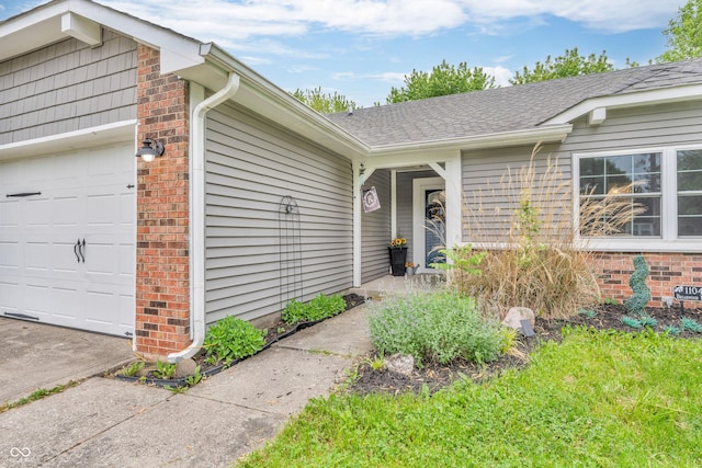 1104 Briarwood Dr, Brownsburg, IN 46112 - view of exterior entry with an attached garage, brick siding, and roof with shingles