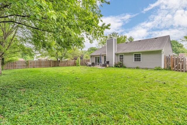 1104 Briarwood Dr, Brownsburg, IN 46112 - rear view of house with a chimney, a patio area, and roof with shingles