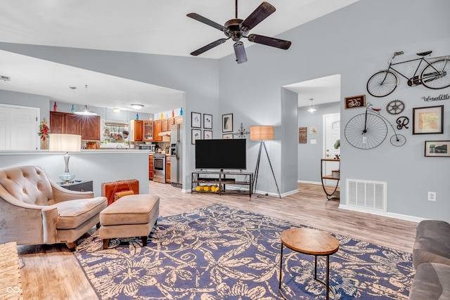 1104 Briarwood Dr, Brownsburg, IN 46112 - living room with ceiling fan, light wood-style flooring, baseboards, and high vaulted ceiling