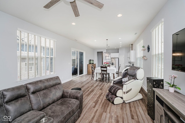 7077 Antiquity Dr, Carmel, IN 46033 - living room featuring light wood-style floors, ceiling fan, plenty of natural light, recessed lighting, and baseboards