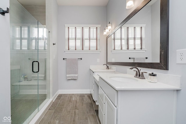 7077 Antiquity Dr, Carmel, IN 46033 - full bath featuring healthy amount of natural light, double vanity, a shower stall, and wood finish floors