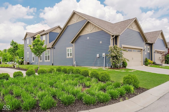 7077 Antiquity Dr, Carmel, IN 46033 - view of side of property featuring board and batten siding, driveway, a yard, a garage, and roof with shingles