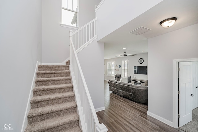 7077 Antiquity Dr, Carmel, IN 46033 - stairway featuring ceiling fan, wood finished floors, and baseboards