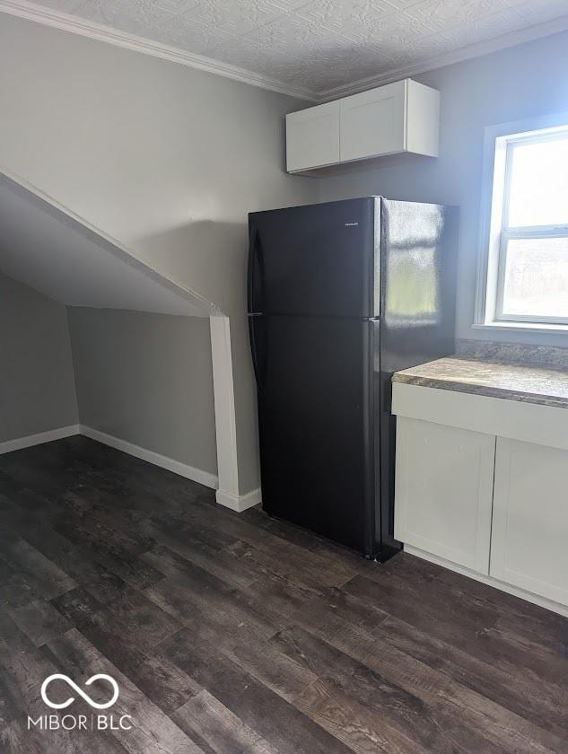 2968 N Arsenal Ave, Indianapolis, IN 46218 - kitchen featuring freestanding refrigerator, white cabinets, dark wood finished floors, ornamental molding, and baseboards