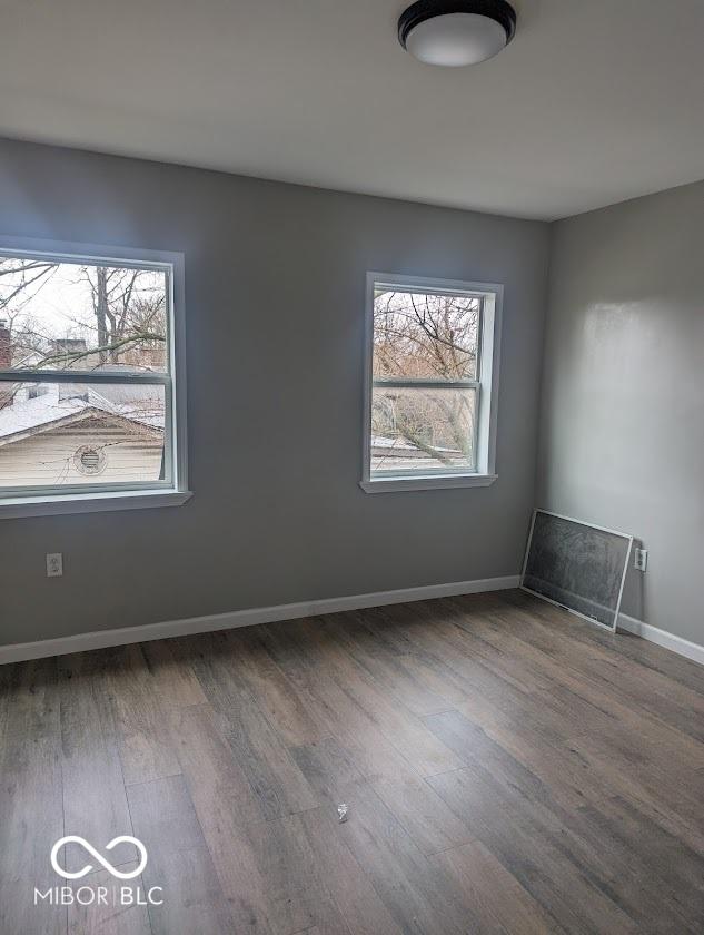2968 N Arsenal Ave, Indianapolis, IN 46218 - unfurnished room with healthy amount of natural light, wood finished floors, and baseboards