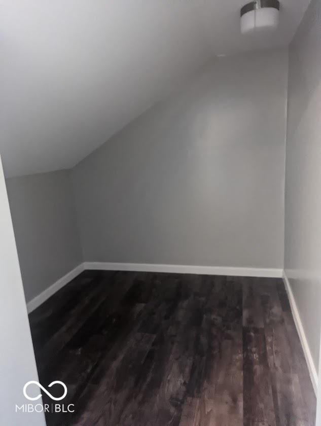 2968 N Arsenal Ave, Indianapolis, IN 46218 - additional living space with vaulted ceiling, wood finished floors, and baseboards