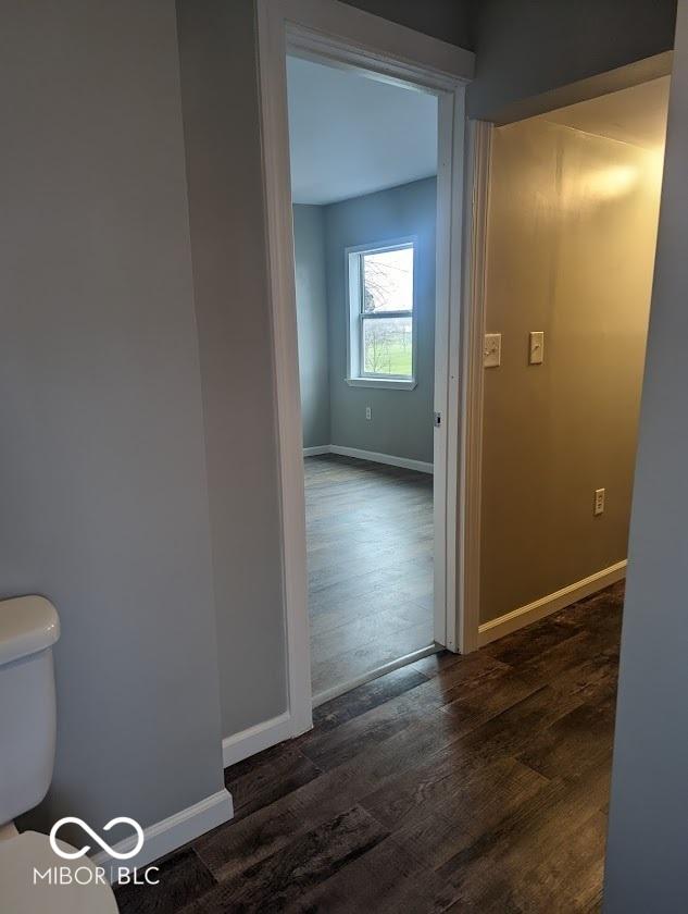 2968 N Arsenal Ave, Indianapolis, IN 46218 - corridor with dark wood-style floors and baseboards
