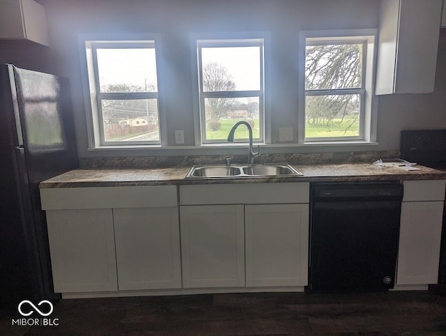 2968 N Arsenal Ave, Indianapolis, IN 46218 - kitchen with dishwasher, a sink, freestanding refrigerator, and white cabinets
