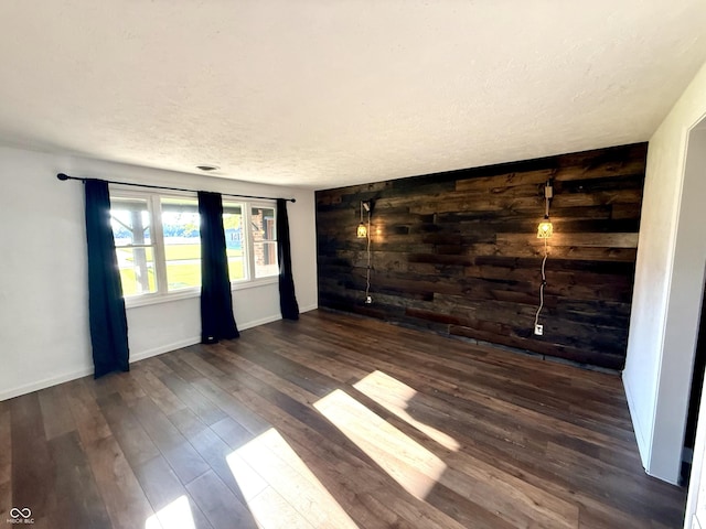 1328 N 300 E, Anderson, IN 46012 - spare room with wood finished floors, a textured ceiling, baseboards, and wood walls