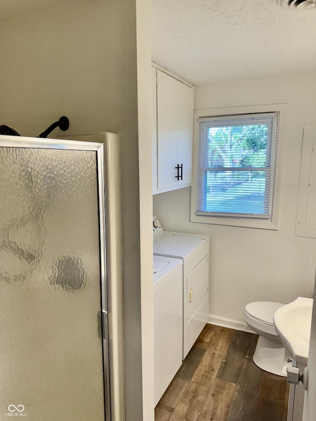 1328 N 300 E, Anderson, IN 46012 - bathroom featuring washer and dryer, a shower stall, wood finished floors, toilet, and baseboards