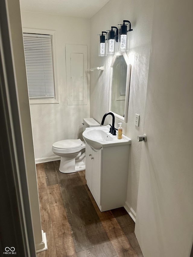 1328 N 300 E, Anderson, IN 46012 - half bathroom featuring hardwood / wood-style flooring, toilet, vanity, and baseboards