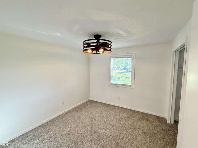 1328 N 300 E, Anderson, IN 46012 - spare room featuring carpet floors, baseboards, and a textured ceiling