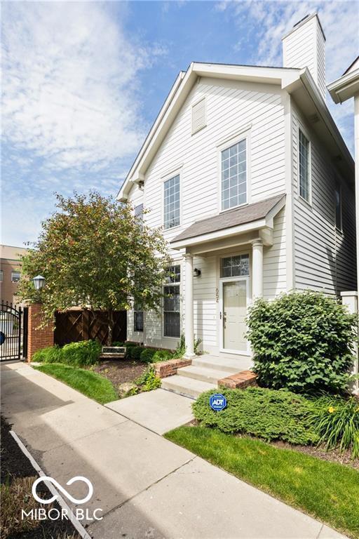 654 N Senate Ave, Indianapolis, IN 46202 - view of front of property featuring a gate and a chimney