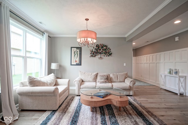 548 Gosford Ct, Westfield, IN 46074 - living room with light wood-style floors, a chandelier, recessed lighting, ornamental molding, and a textured ceiling