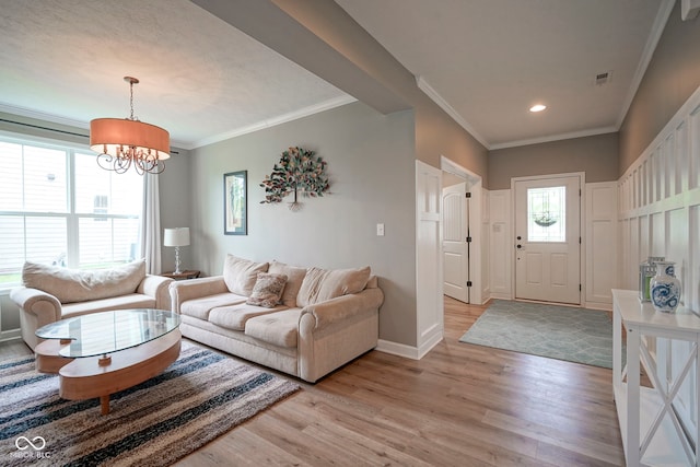 548 Gosford Ct, Westfield, IN 46074 - living room featuring light wood finished floors, a chandelier, ornamental molding, and recessed lighting