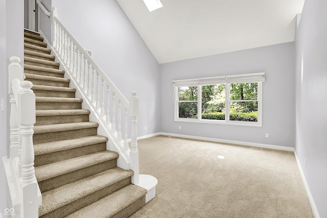 7513 Pine Royal Dr, Indianapolis, IN 46256 - staircase with carpet, high vaulted ceiling, and a skylight