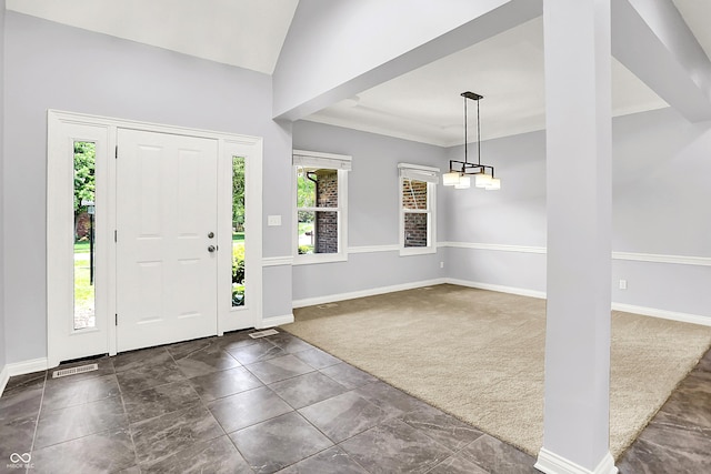 7513 Pine Royal Dr, Indianapolis, IN 46256 - foyer entrance with dark colored carpet, a chandelier, and lofted ceiling