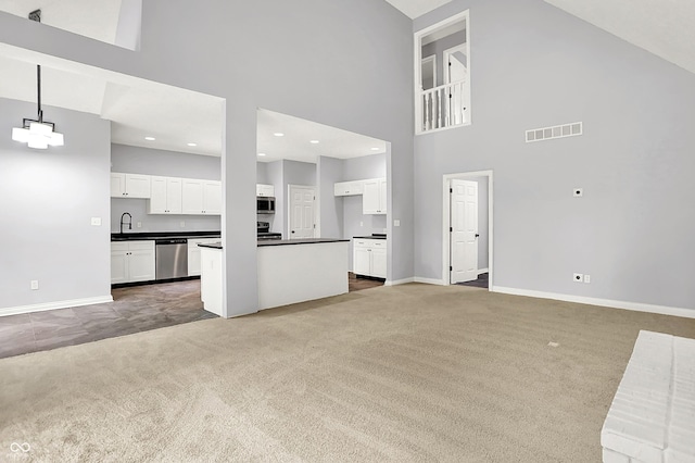 7513 Pine Royal Dr, Indianapolis, IN 46256 - unfurnished living room featuring carpet, a towering ceiling, and recessed lighting