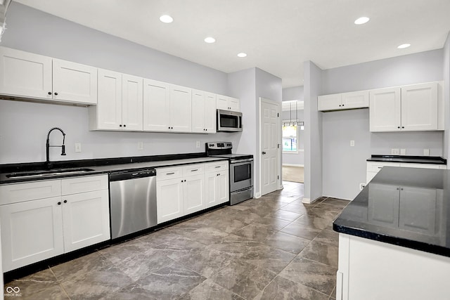 7513 Pine Royal Dr, Indianapolis, IN 46256 - kitchen featuring appliances with stainless steel finishes, white cabinetry, and recessed lighting
