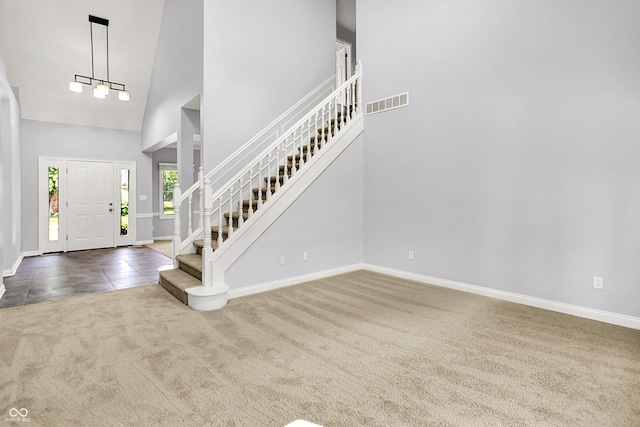 7513 Pine Royal Dr, Indianapolis, IN 46256 - foyer featuring carpet flooring, a high ceiling, and stairs