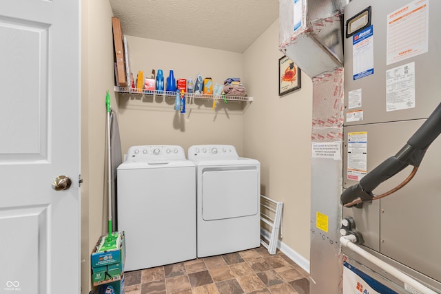10731 Jimmy Lake Dr, Indianapolis, IN 46239 - washroom featuring washer and dryer, heating unit, stone finish flooring, and baseboards