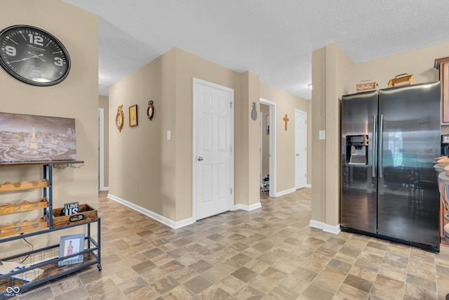 10731 Jimmy Lake Dr, Indianapolis, IN 46239 - kitchen featuring stainless steel fridge, light stone finish flooring, and baseboards
