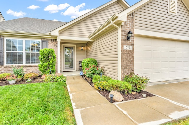 10731 Jimmy Lake Dr, Indianapolis, IN 46239 - doorway to property with brick siding, a garage, driveway, and a yard
