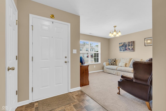 10731 Jimmy Lake Dr, Indianapolis, IN 46239 - carpeted foyer entrance featuring baseboards, a chandelier, and stone finish floors